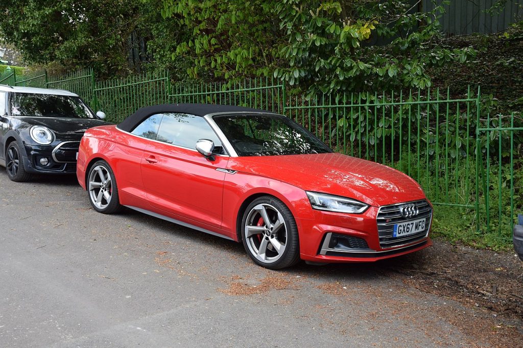 Red 2017 Audi S5 convertible luxury sports car parked on street with modern styling