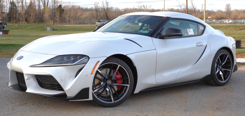 White 2020 Toyota GR Supra modern sports car with sleek design parked on pavement outdoors