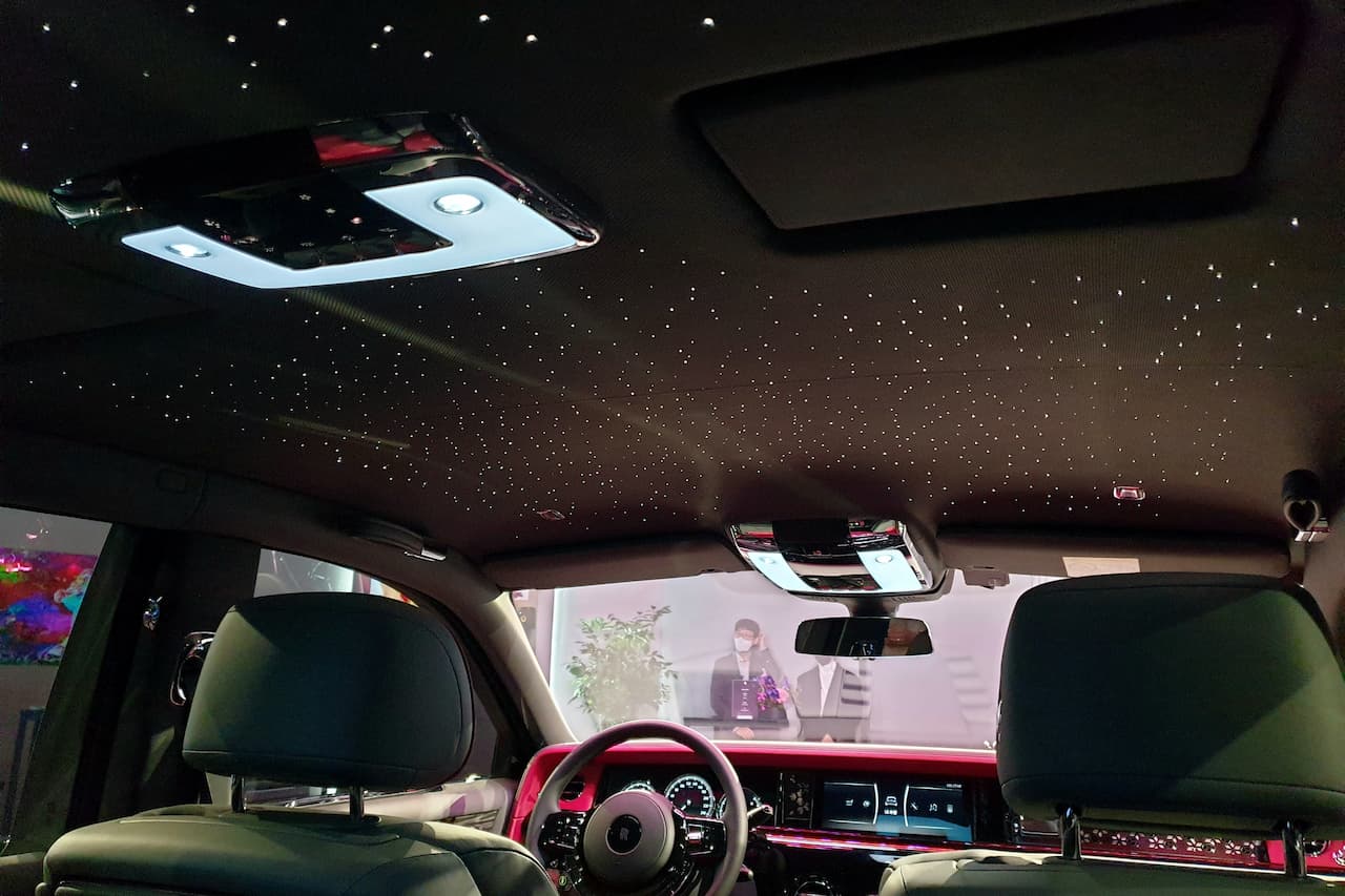 Rolls-Royce Starlight Headliner featuring hundreds of fiber optic lights creating starry sky effect on black ceiling