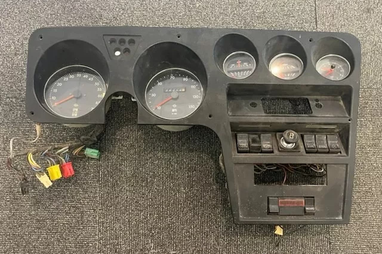 Opel's late 1970s trip computer dashboard panel with analog gauges, digital display, control buttons, and wiring harnesses