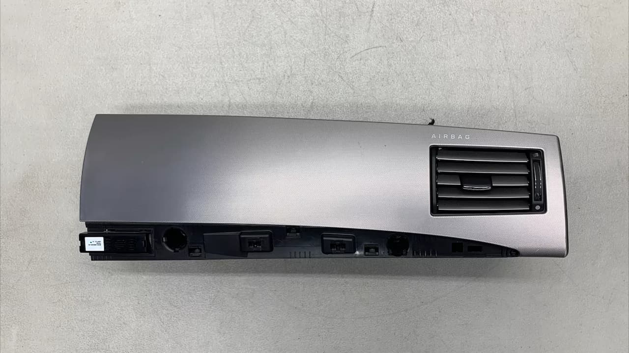 Jaguar XF dashboard component with "AIRBAG" text, air vent, and multiple electrical connectors visible on back side