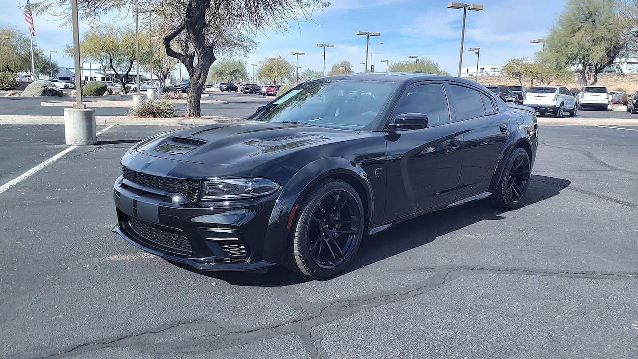 Dark gray Dodge Charger SRT Hellcat Redeye with black wheels parked in shopping center parking lot