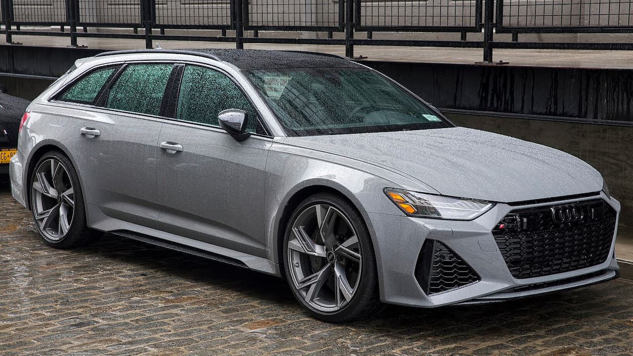 Silver Audi RS6 Avant with black honeycomb grille and large alloy wheels parked in urban concrete setting