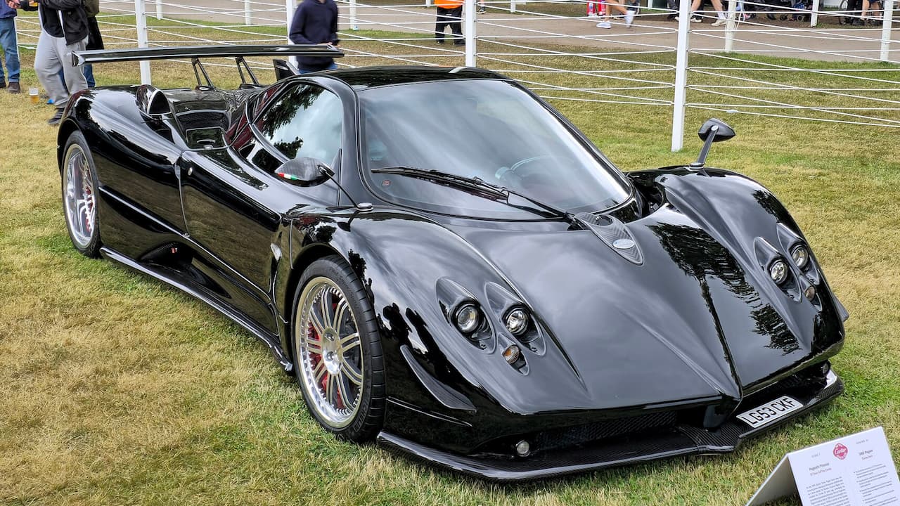 Black Pagani Zonda supercar with distinctive aerodynamic bodywork displayed on grass at automotive show event