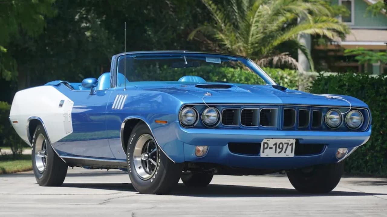 Blue and white 1971 Plymouth Hemi 'Cuda convertible with hood scoop and rally wheels parked on residential street