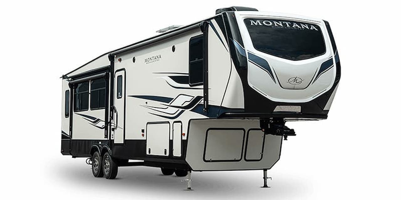 White and black Keystone Montana fifth wheel trailer with angular graphics and stabilizer jacks on white background