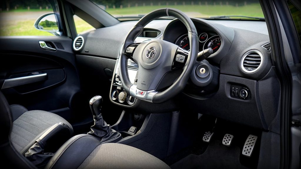 Car interior showing steering column and multifunction steering wheel