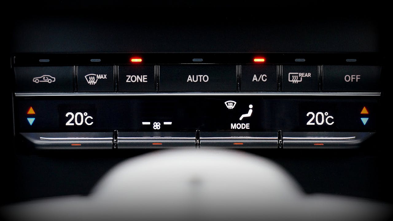 Digital tri-zone climate control panel displaying 20°C temperature settings with AUTO, A/C, ZONE, and MODE buttons illuminated
