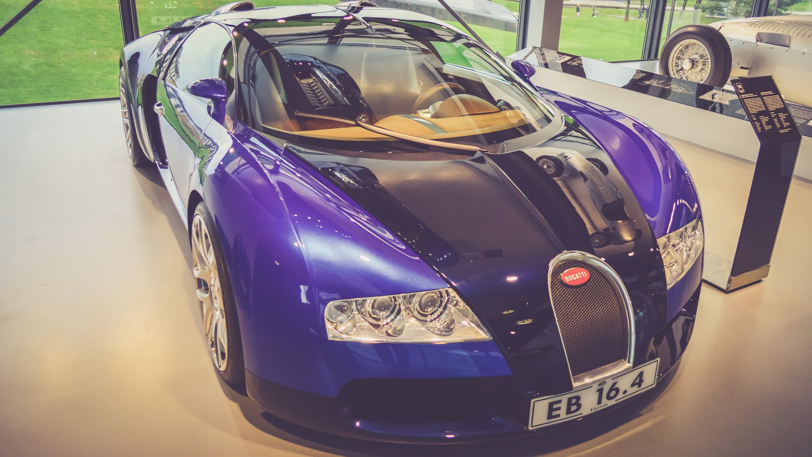 Luxury Bugatti Veyron sports car showcased elegantly in an indoor exhibition.