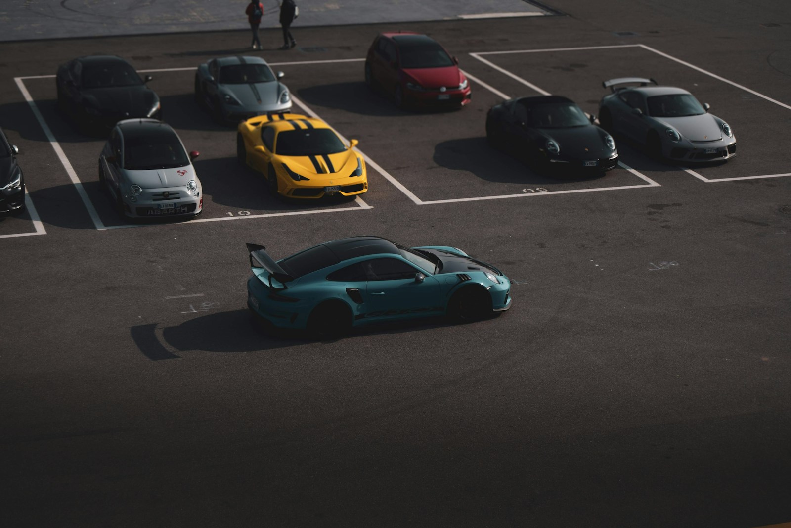 A parking lot filled with lots of different colored cars