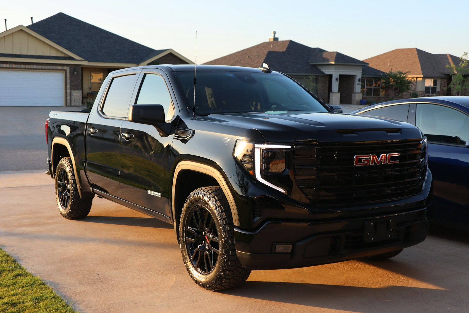 a black truck parked in a driveway