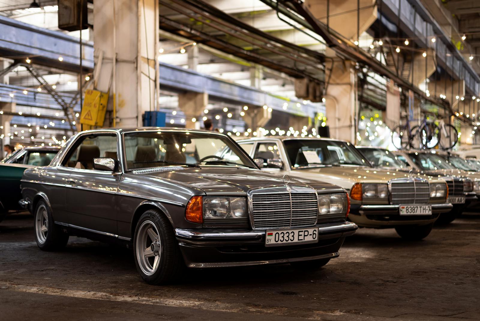 Classic Mercedes-Benz cars lined up at an indoor exhibition in Minsk, Belarus.