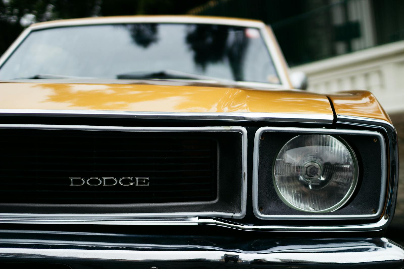 Front close-up of a vintage Dodge car with shiny chrome details in Curitiba, Brazil.