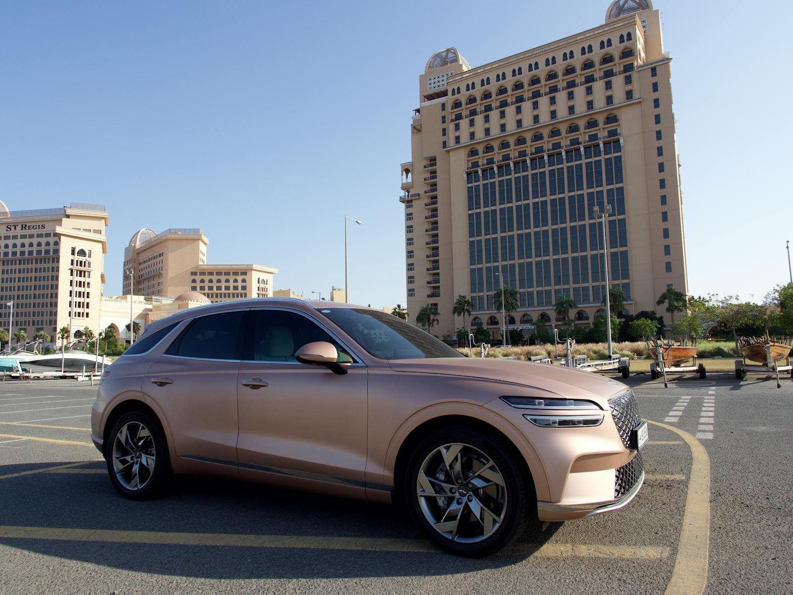 Stylish luxury SUV parked in front of modern architecture in Doha, Qatar.