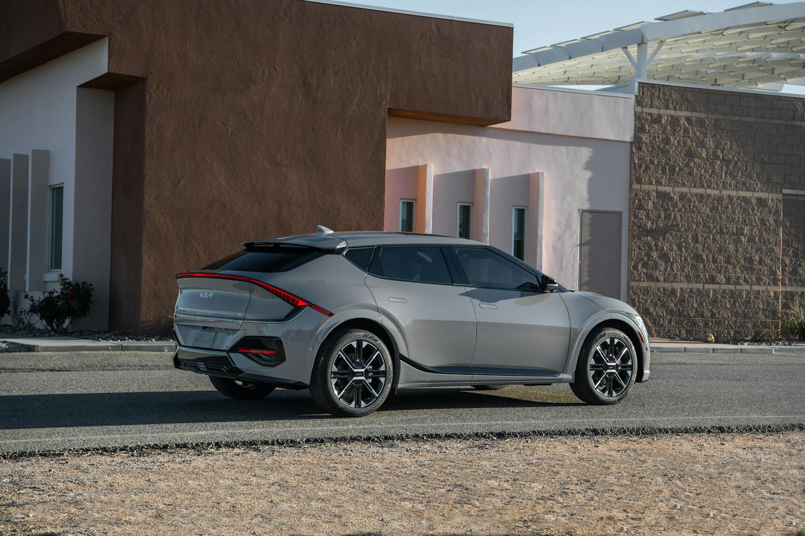 Sleek Kia EV6 GT-Line parked outside a modern building, showcasing futuristic design and innovation.