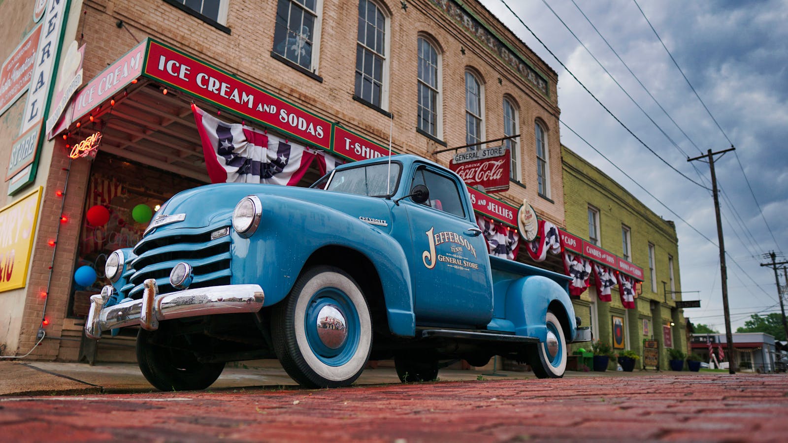 Vintage blue Chevrolet truck parked outside Jefferson General Store in Texas.