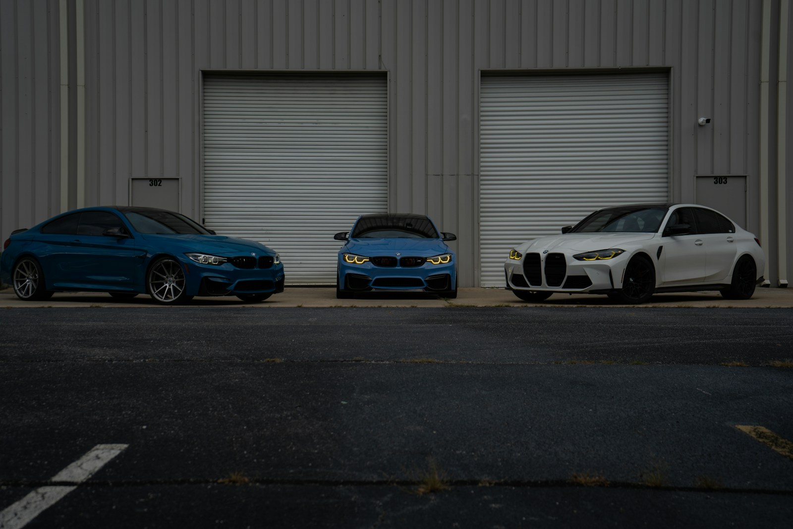 Three bmws parked in front of a building.