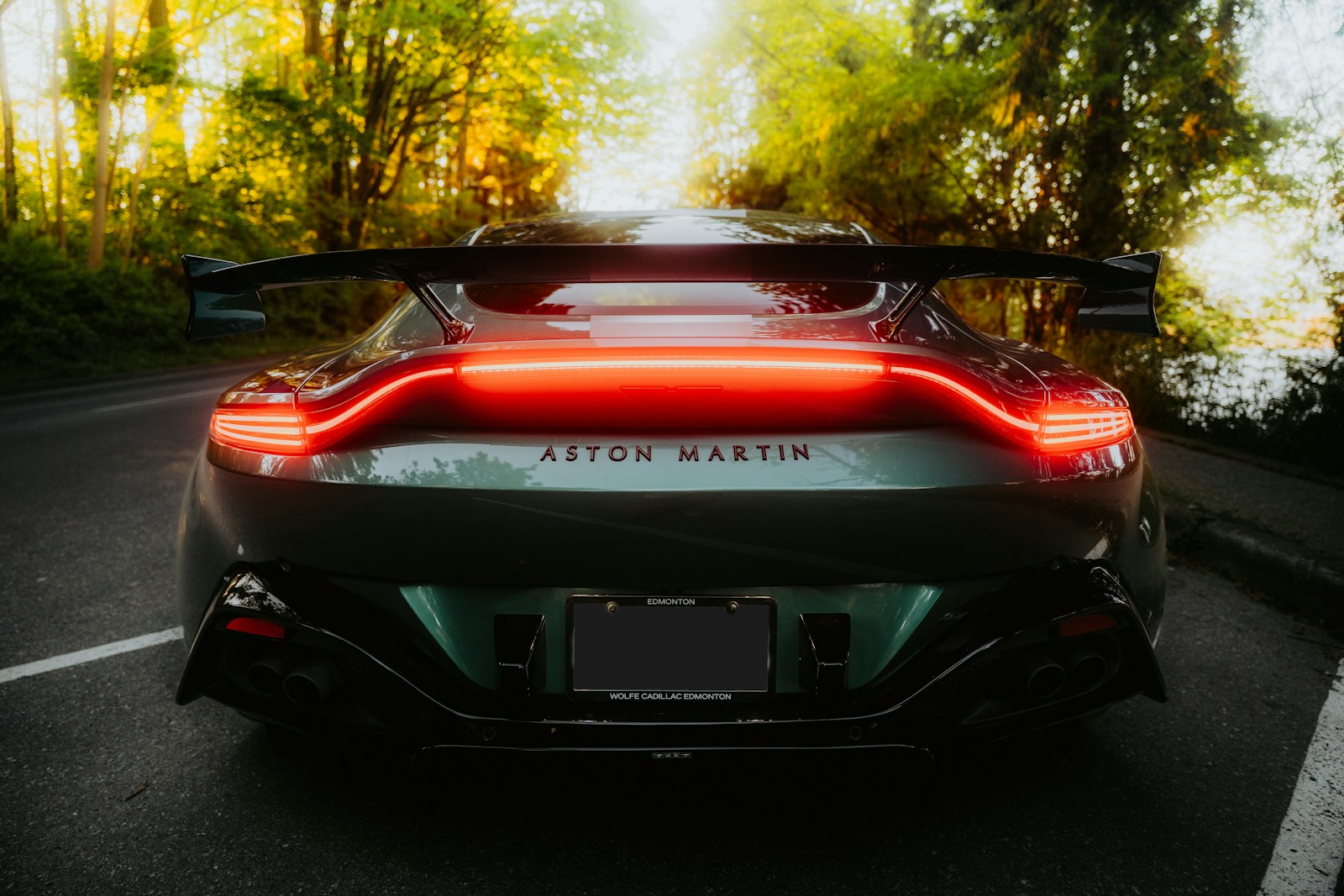 Aston martin car driving on the road.