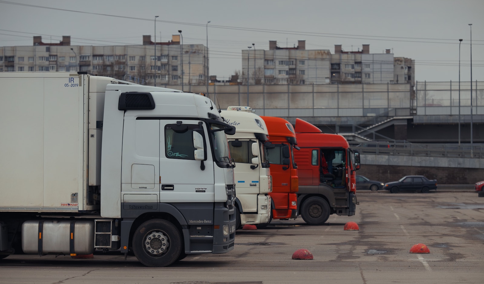 Trucks are parked in a row in a parking lot.