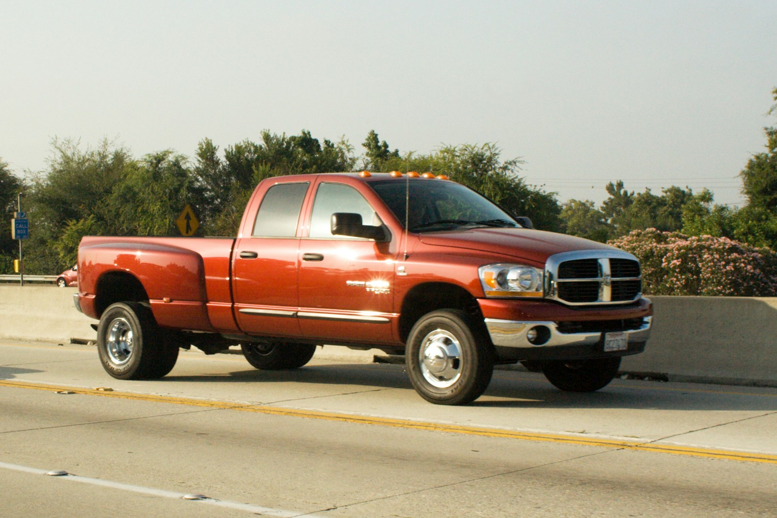 Orange dually pickup truck on a highway