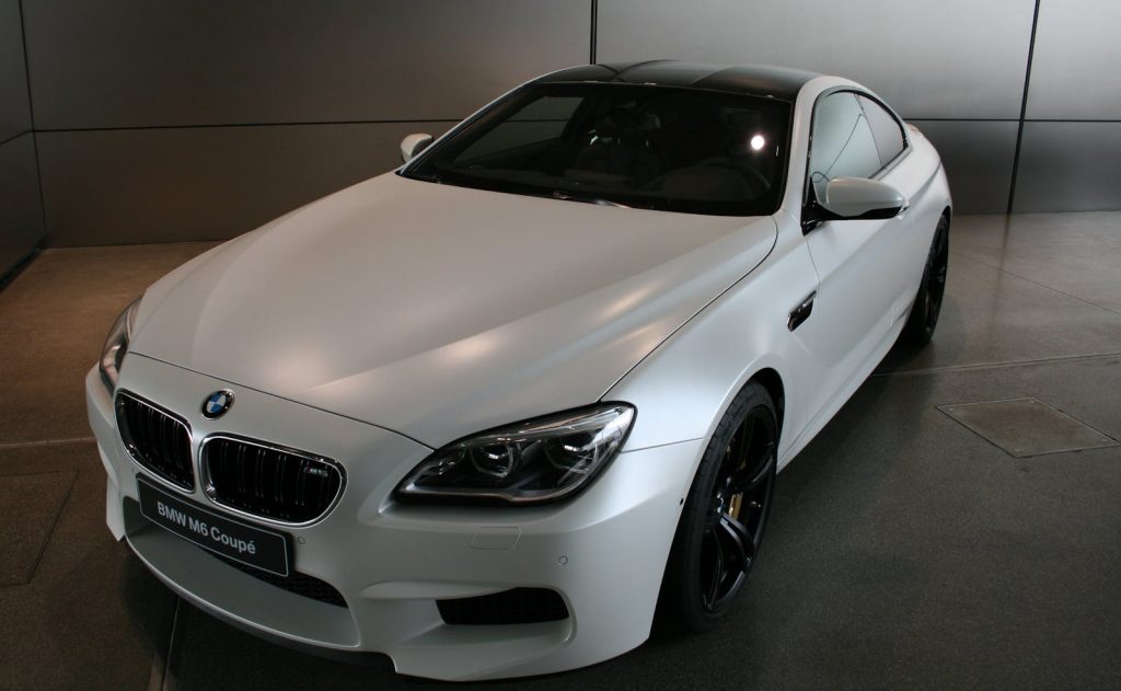 Sleek BMW M6 Coupé in a showroom highlighting luxury and performance.