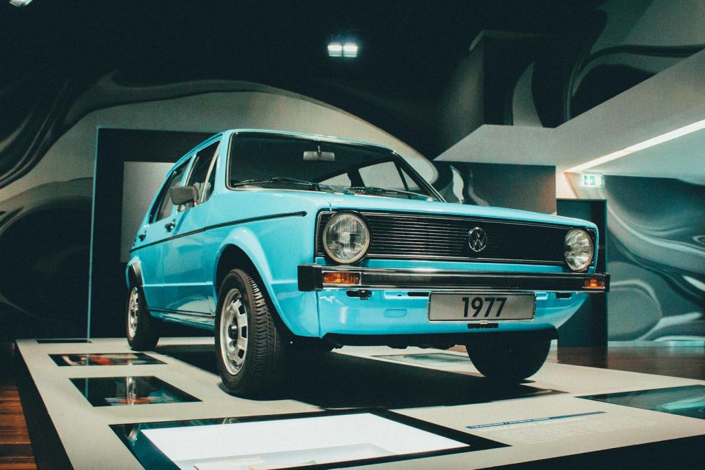 Showcasing a classic 1977 Volkswagen in a modern exhibition setting, highlighting its vintage design.