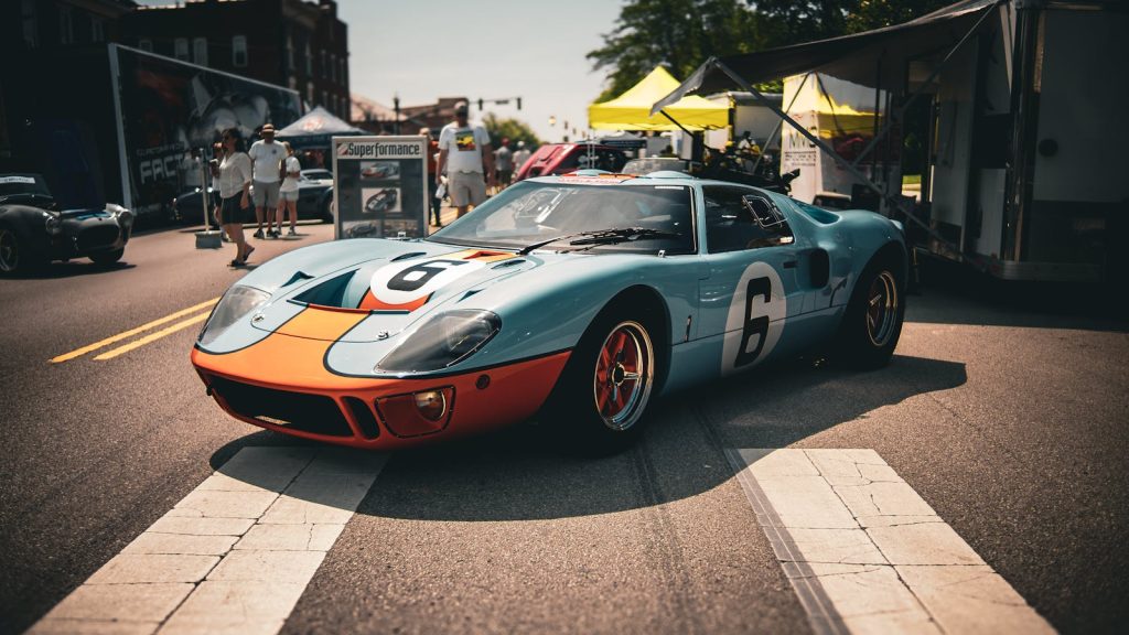 Classic blue and orange vintage race car showcased at an outdoor car show in London, Ohio.
