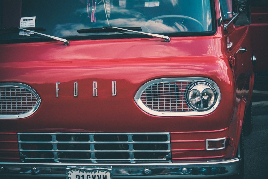 a red ford truck parked in a parking lot