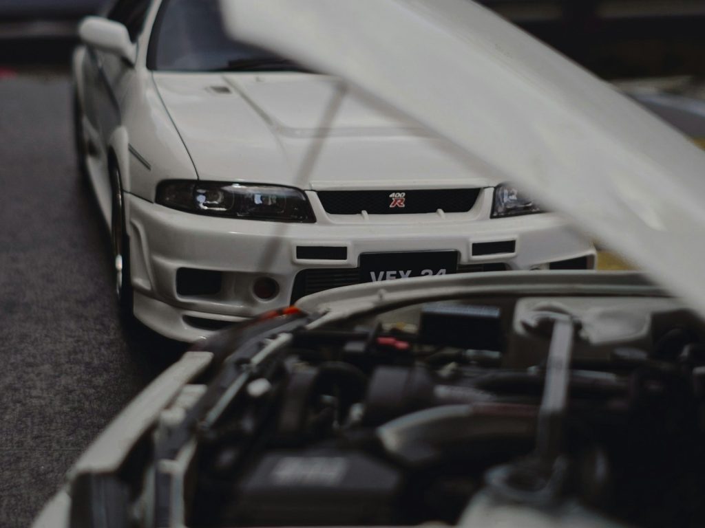 Two white cars are parked close to each other.
