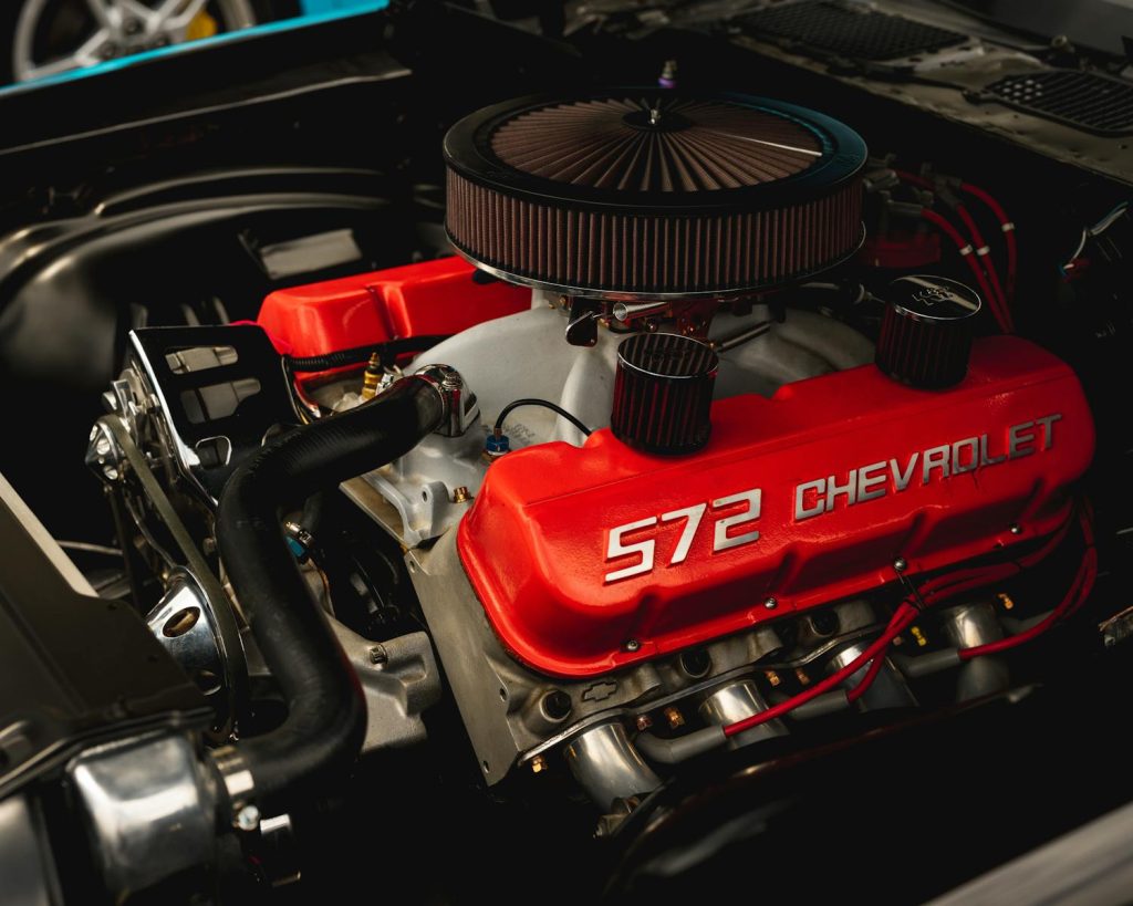 Detailed closeup of a Chevrolet 572 engine with vibrant red valve covers.