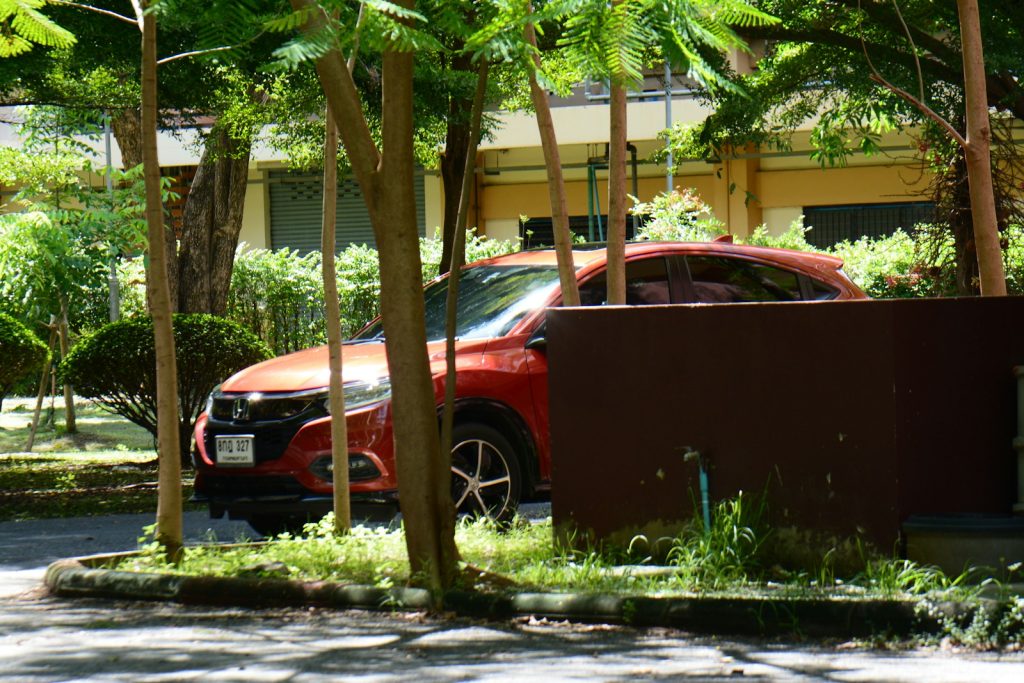 a red car parked in front of a building