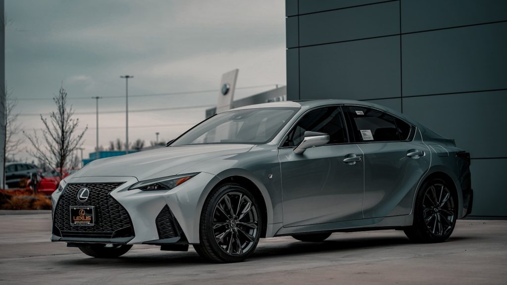 a silver car parked outside a building