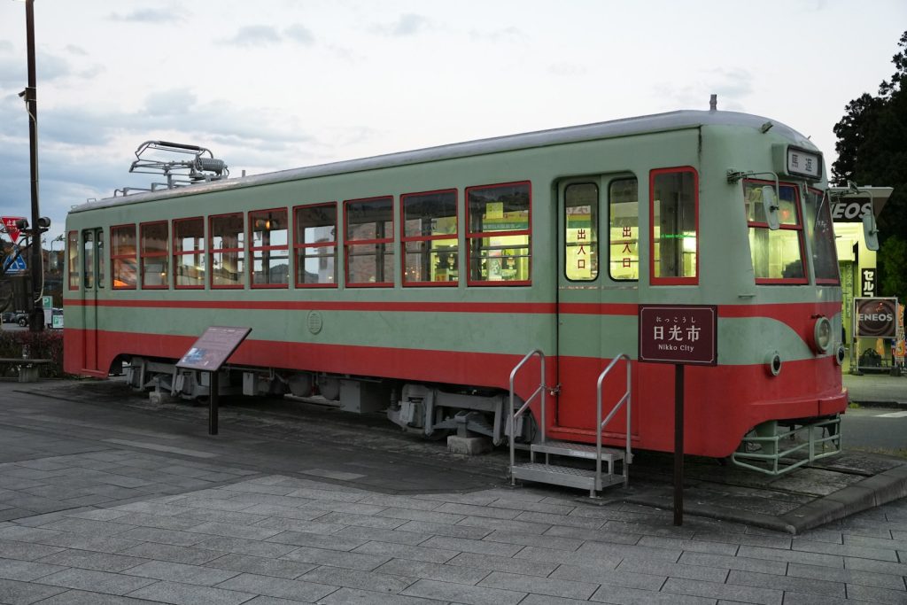 Vintage tram car with red and green stripes.