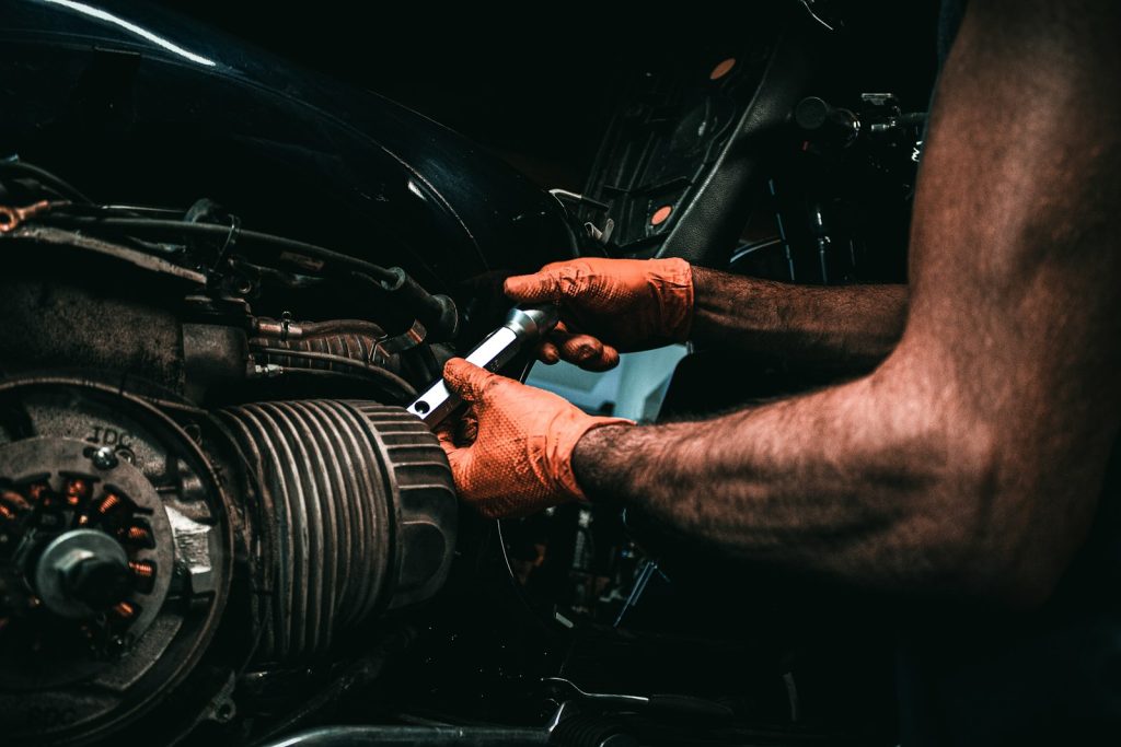 a man working on a car engine with a wrench