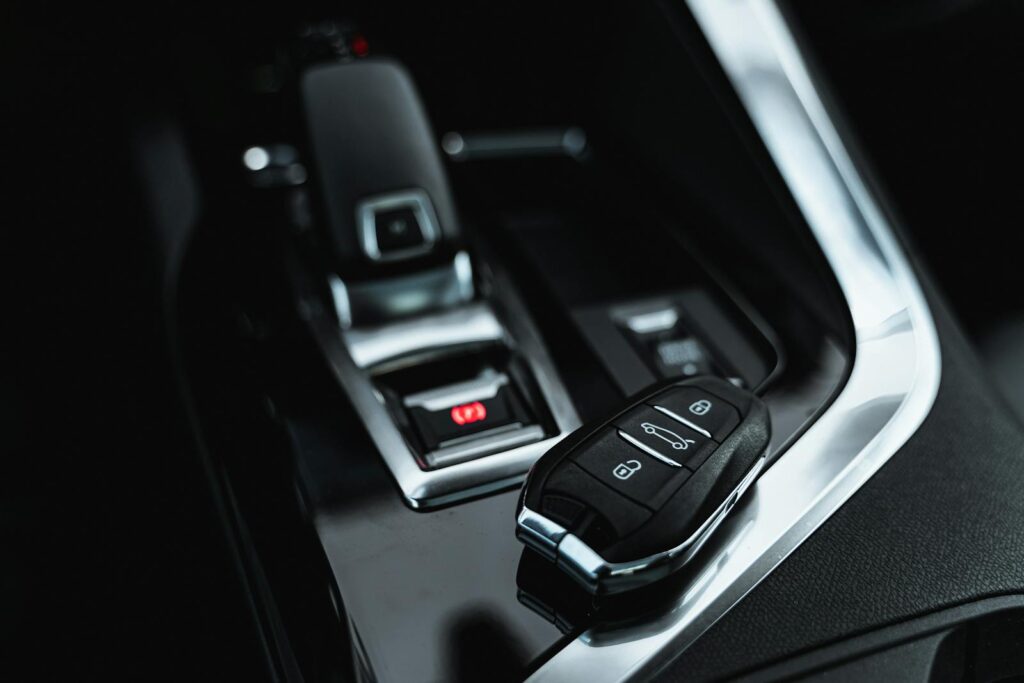 Close-up of modern car interior featuring a sleek car key and shifter, showcasing luxury design.