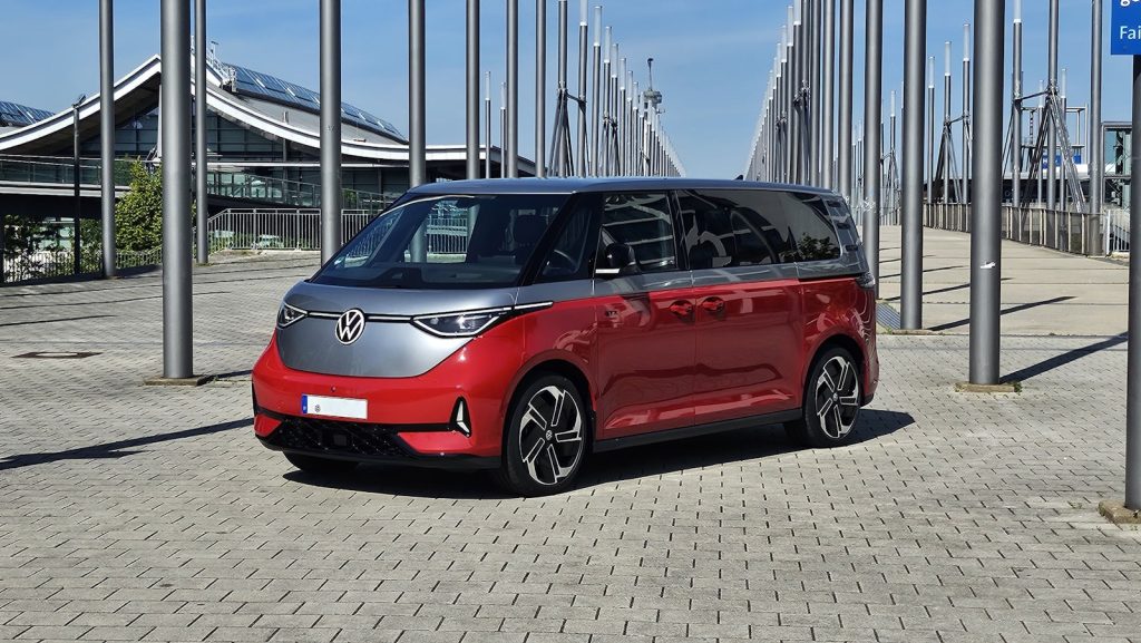Red and silver van parked outdoors near stadium structure