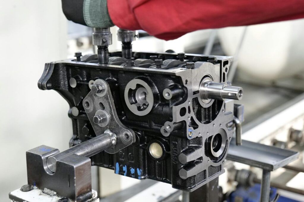 Close-up of engine assembly process highlighting industrial precision