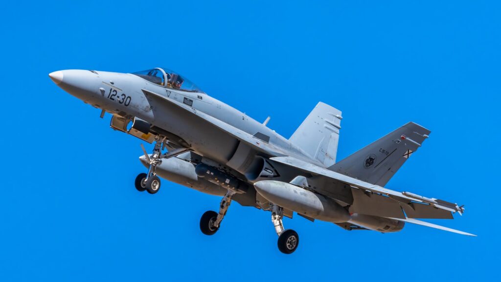 F/A-18 Hornet fighter jet soaring through clear blue sky, showcasing its powerful design and engineering.