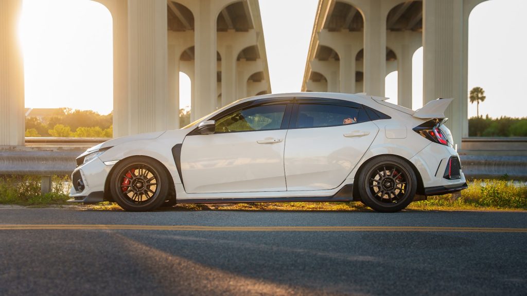 Honda civic type r under a bridge at sunset