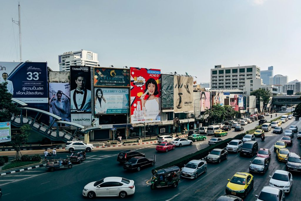 Dynamic cityscape of Bangkok showcasing heavy traffic and colorful billboards in the metropolis.