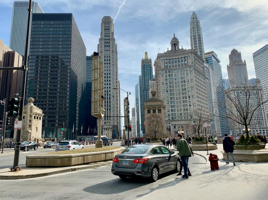 A bustling Chicago downtown scene with iconic skyscrapers and street activity.