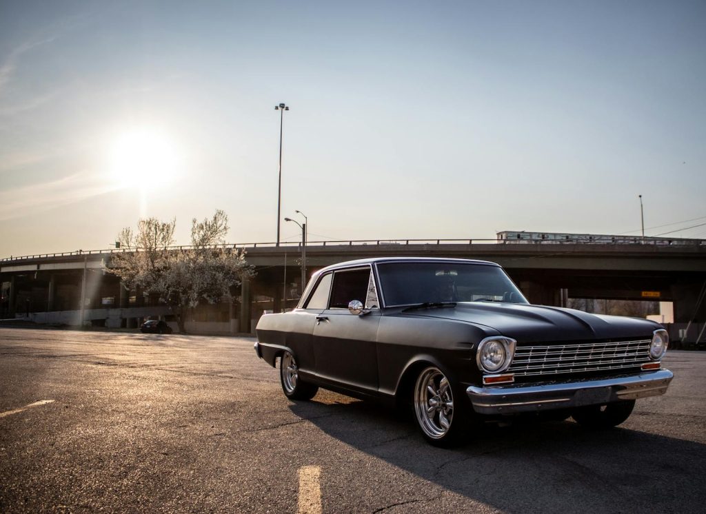A vintage Chevrolet Nova captured during sunset in an urban setting of Kansas City.