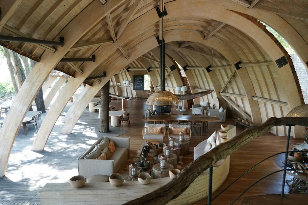 A room with a wooden ceiling and a long wooden table