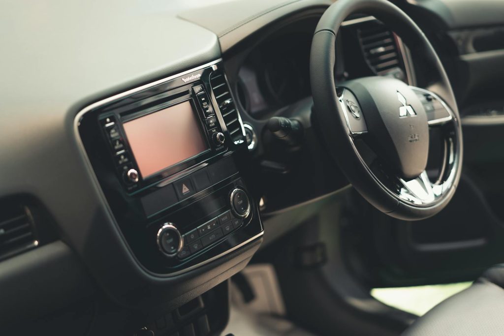 Detailed close-up of a modern car dashboard and steering wheel emphasizing sleek design.