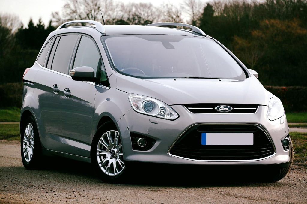 Silver Ford C-Max SUV parked on a road in the UK. Ideal for automotive themes.