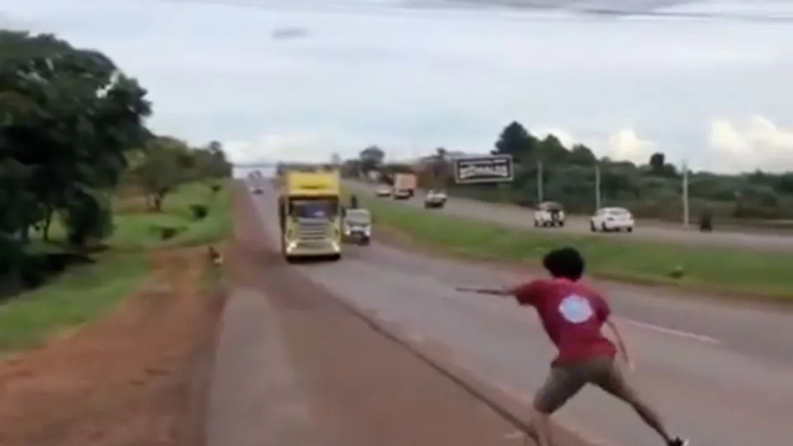Terrifying moment teen plays a twisted game of chicken with a massive 12-wheeler, nearly causing disaster