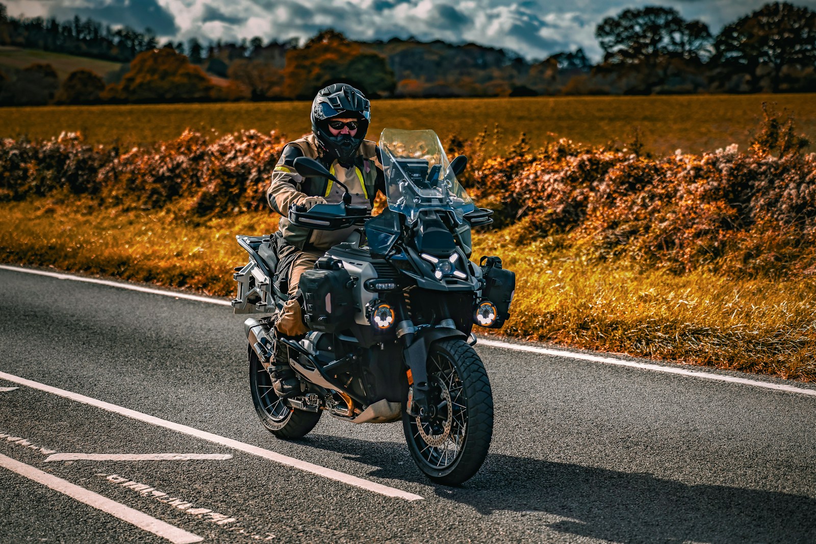 Man riding motorcycle on a paved road