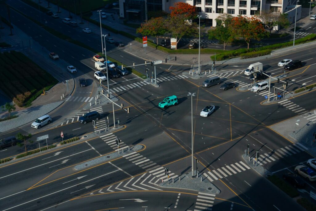 An aerial view of a city intersection with cars