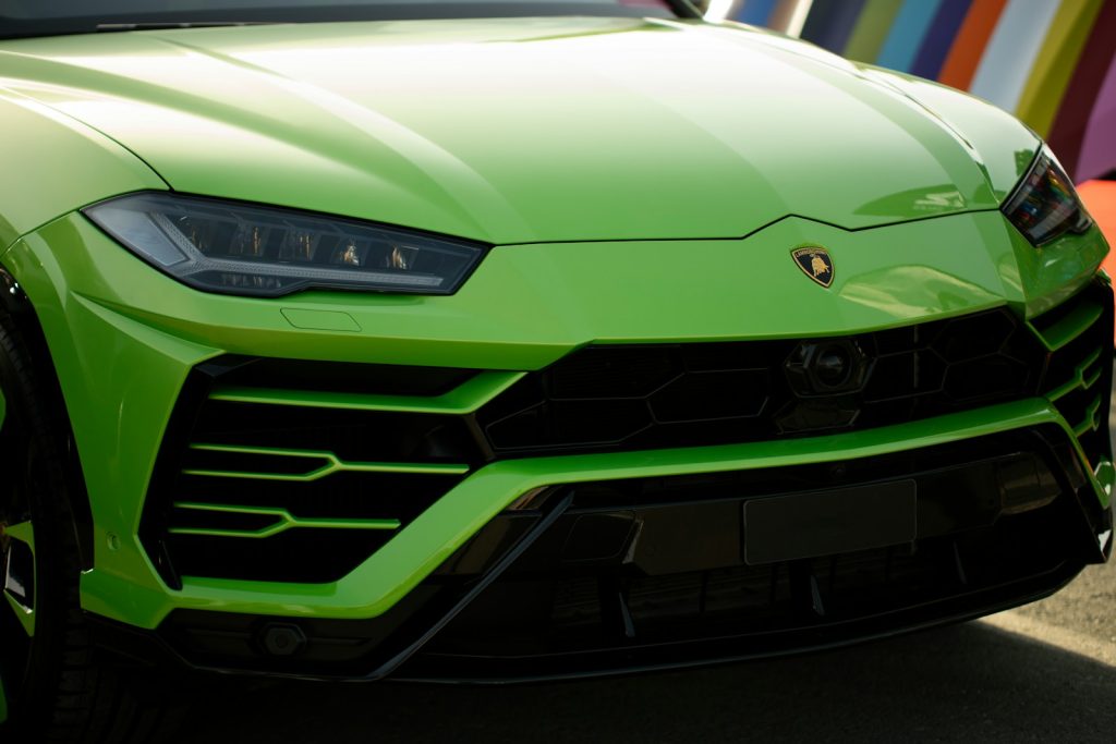 A bright green luxury suv front detail