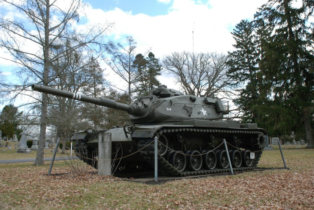 black battle tank on green grass field during daytime